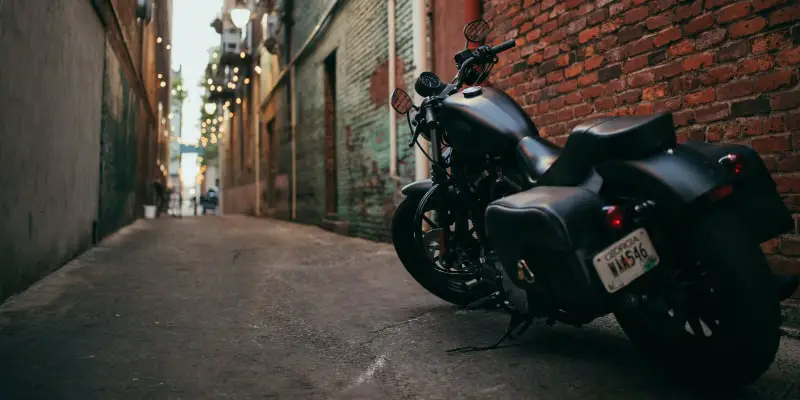 Motorcycle parked in an alleyway