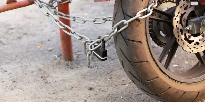 Parked motorcycle secured with lock and chain