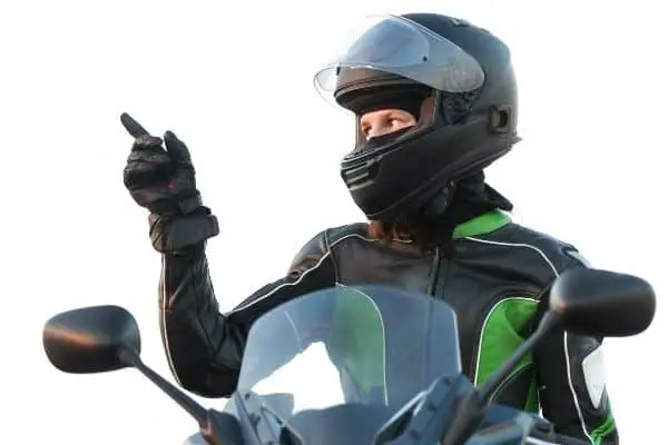 Woman wearing black and green leather jacket and helmet
