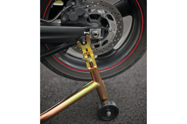 Black and gold paddock stand used on motorcycle