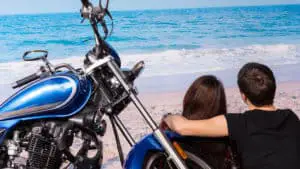 Couple on a motorcycle date at the beach