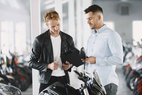 man talking to motorcycle dealer