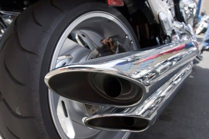 Closeup of tip of long motorcycle exhaust pipes