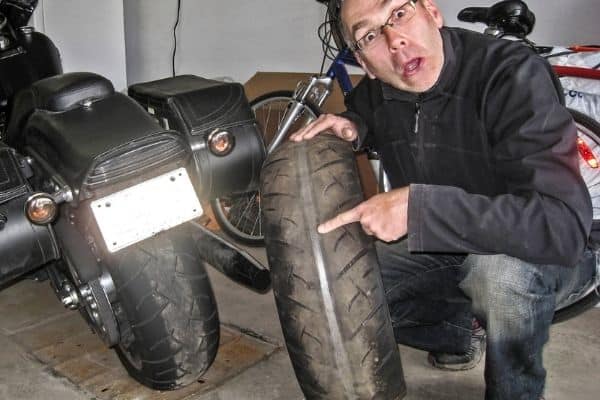 A Man Showing His Motorcycle Tire