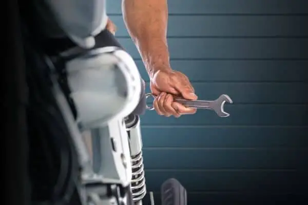 Motorcycle Mechanic Holding A Wrench