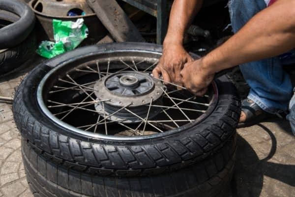 Person Fixing Used Radial Motorcycle Tire