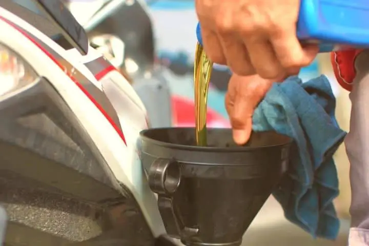 Man Is Pouring Oil In Motorcycle Engine