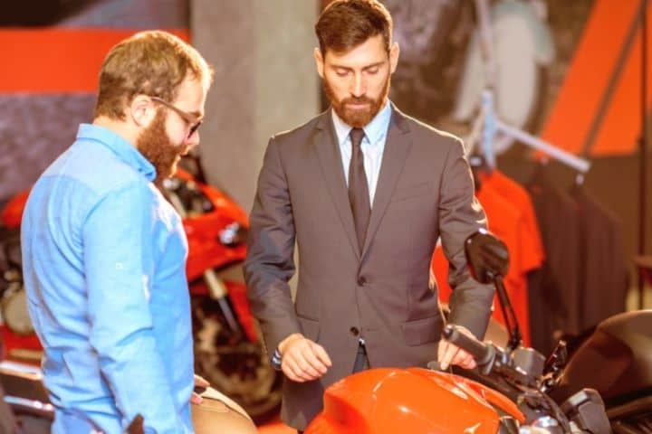 Men Look At Motorcycle