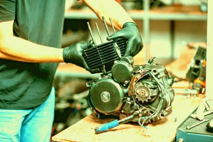 Man Is Holding Motorcycle Engine