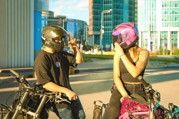 Couple Looks At Each Other While Sitting On Motorcycles