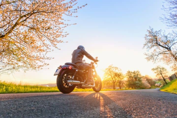 Man Riding A Motorcycle At Sunset