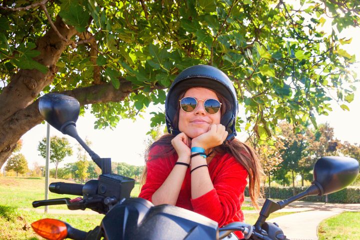 Woman With Helmet Is Sitting On Motorcycle