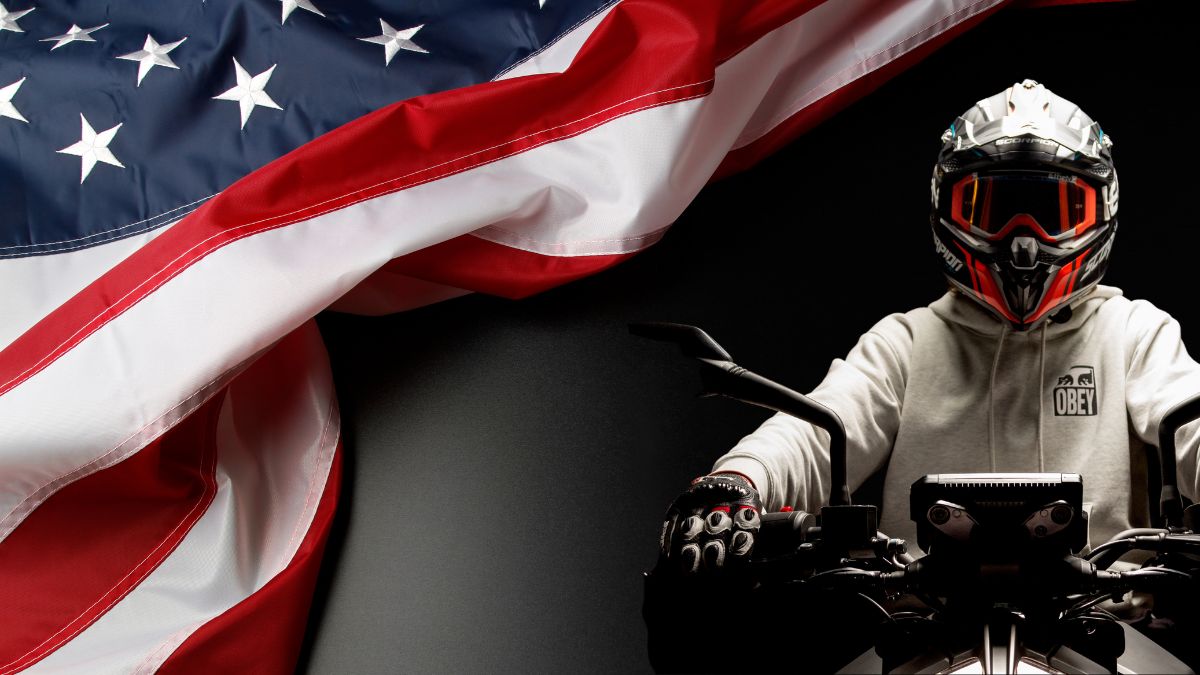 A Motorcycle Rider Wearing A Helmet Against A Black Backdrop With American Flag