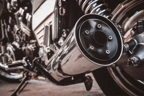 A Motorcycles Big Exhaust Pipe With A Muffler