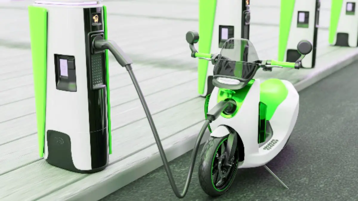 An Electric Motorcycle At A Charging Station