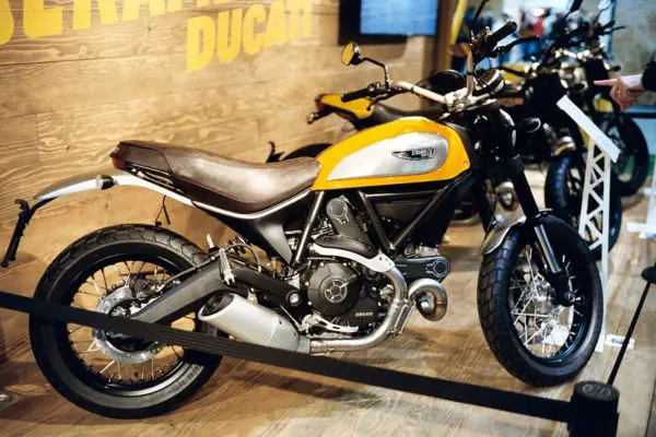 Black And Yellow Ducati Scrambler Icon At A Motor Show